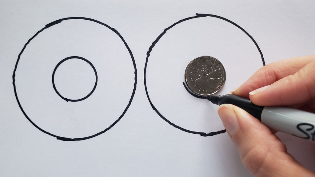 A coin is traced inside a larger circular shape