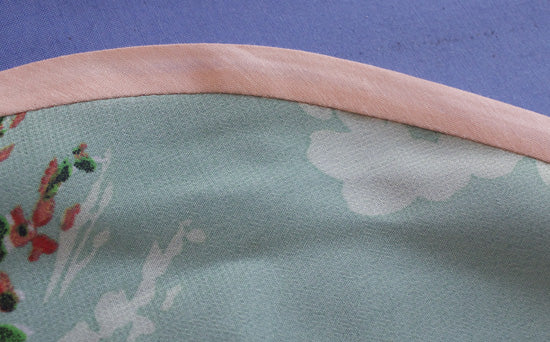 Single fold binding pressed netly from right side of garment