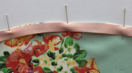 Binding turned and pinned towards wrong side of garment