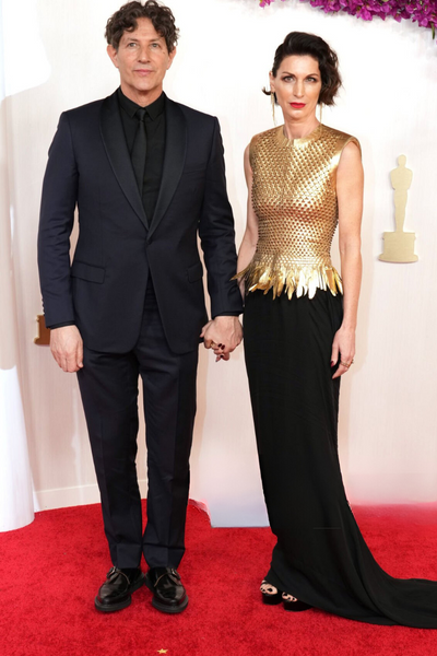 Rachael Penfold in a Giles Deacon gold top with husband Jonathan Glazer