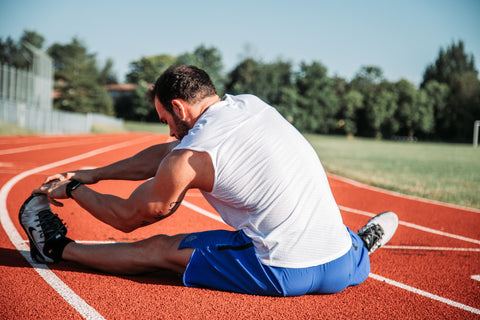 Man stretching on the track