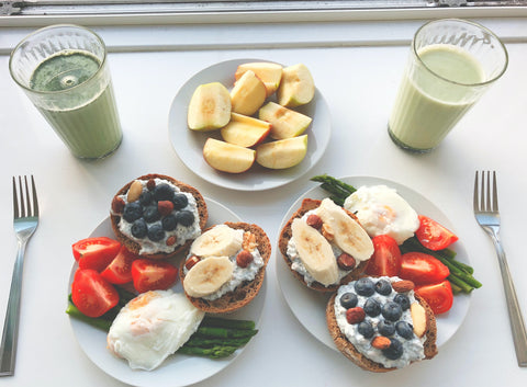 A breakfast with fruit, toast, eggs, and juice