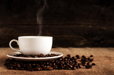 Coffee in white cup and coffee beans