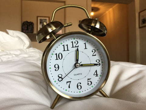 Alarm clock next to bed, set a bedtime