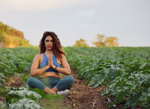 Woman meditating in a field