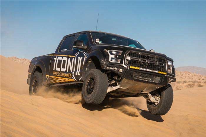 Icon Vehicle Dynamics Ford Raptor jumping in sand dunes