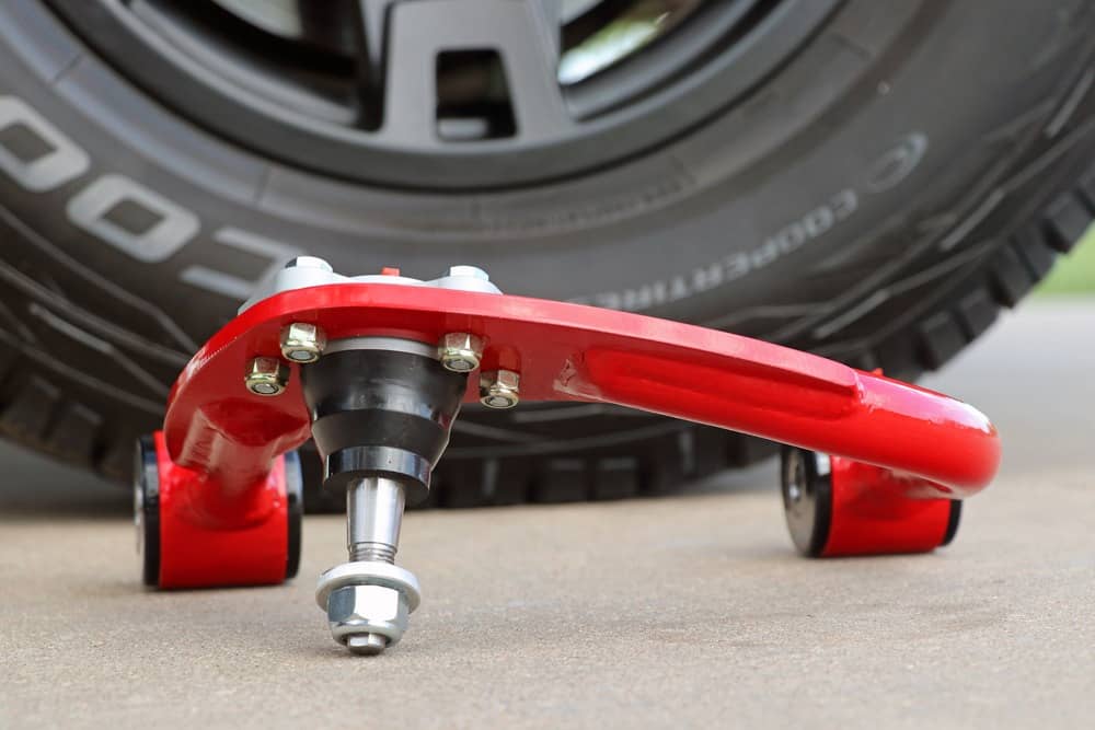 what does an upper control arm do