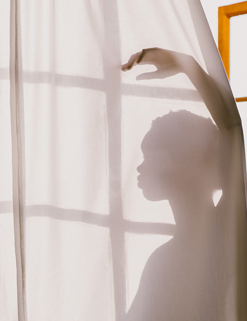 lady silhouette behind curtain