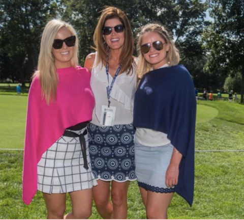 3 ladies smiling while on a golf course