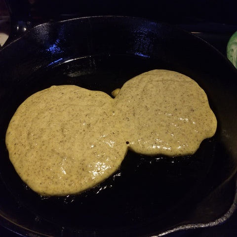 Buckwheat pancakes being cooked on a cast iron skillet