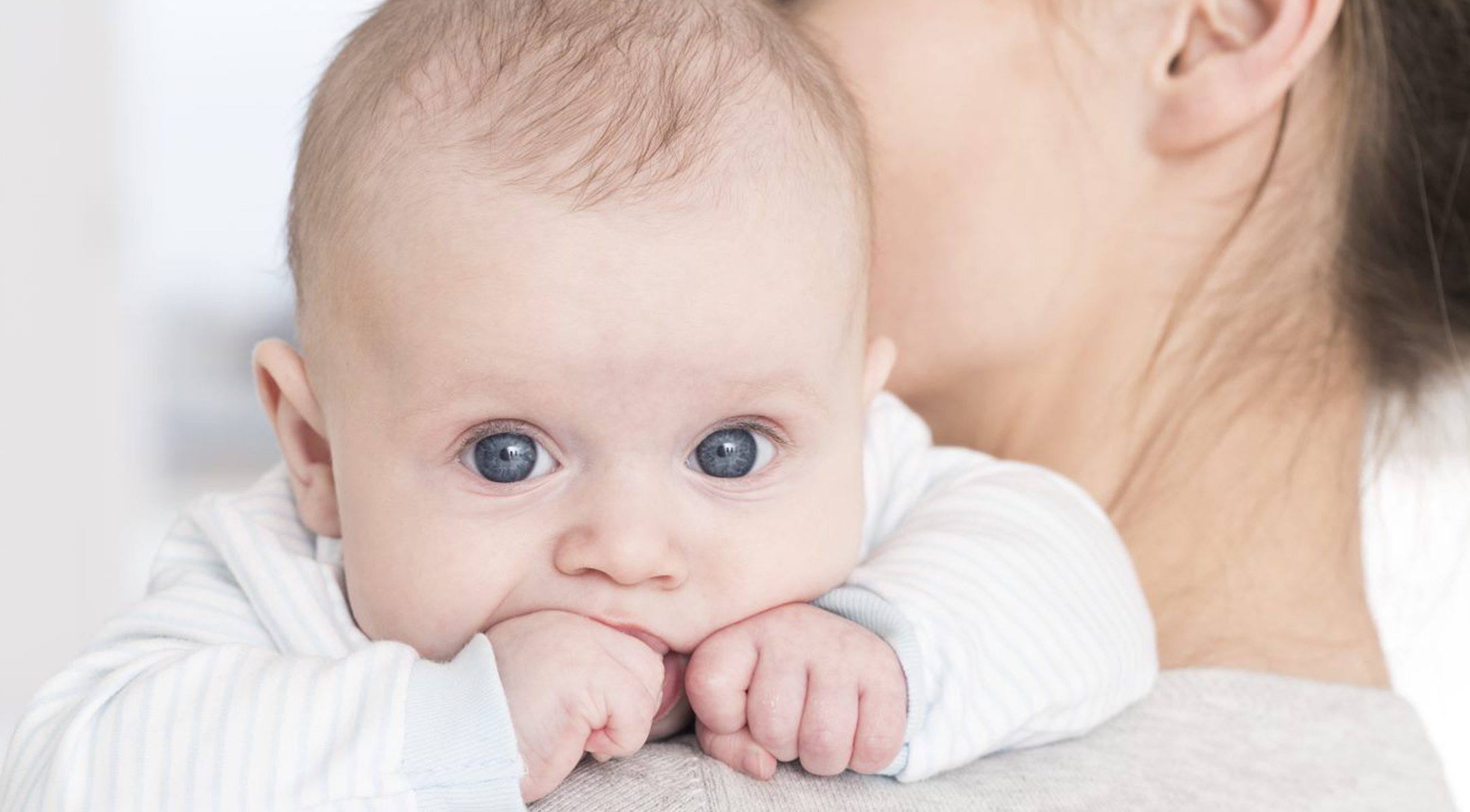 Mother with baby leaning on moms shoulder