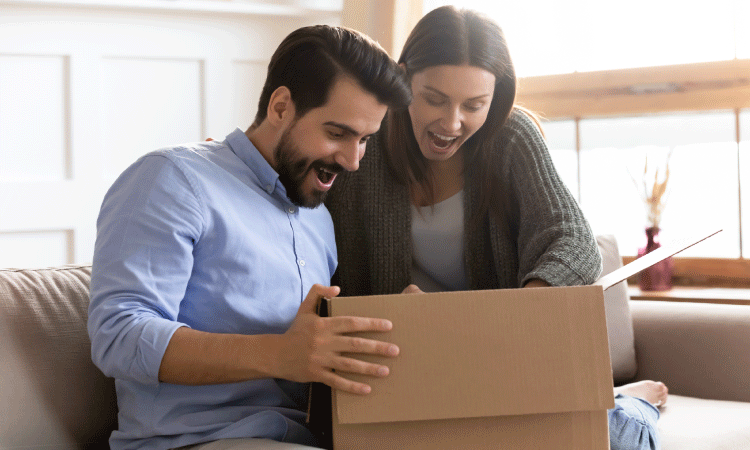 Couple opening a package they received in the mail.