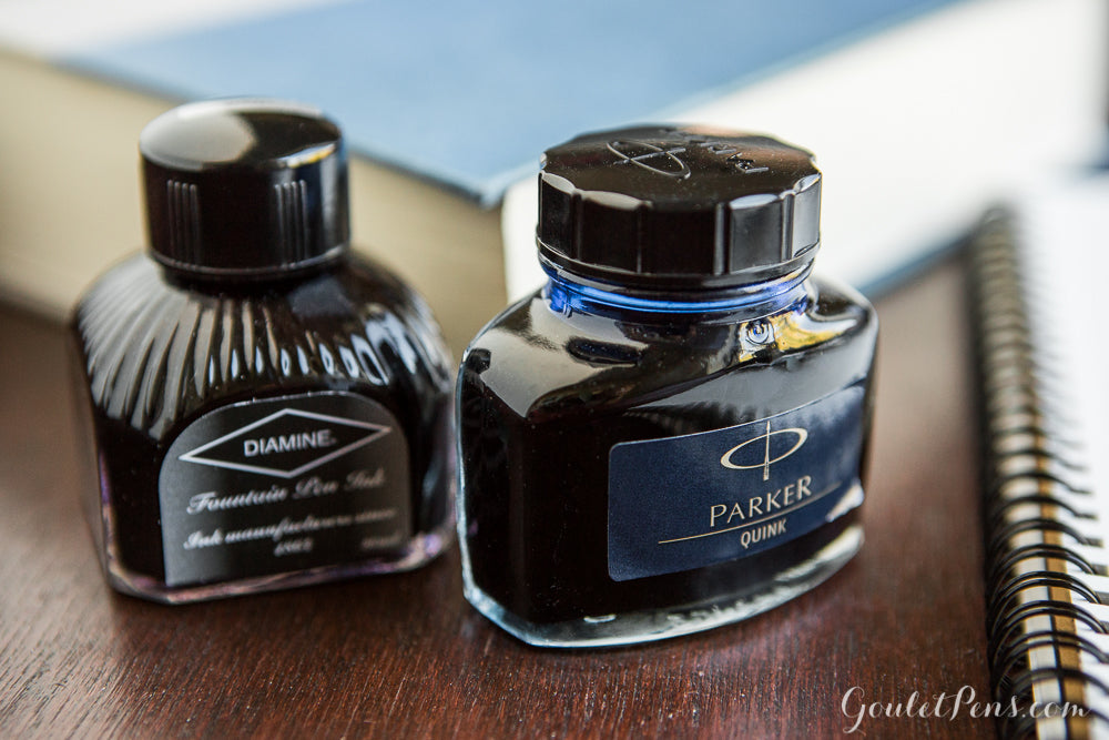 close up of some ink bottles on a desk