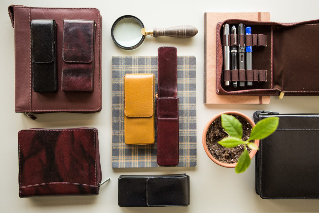 Girologio Pen Cases with pens and notebooks on a desk