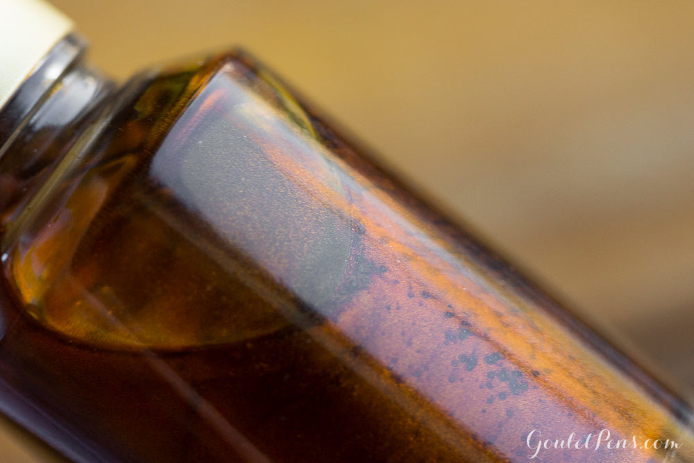 Brown shimmering fountain pen ink in a bottle