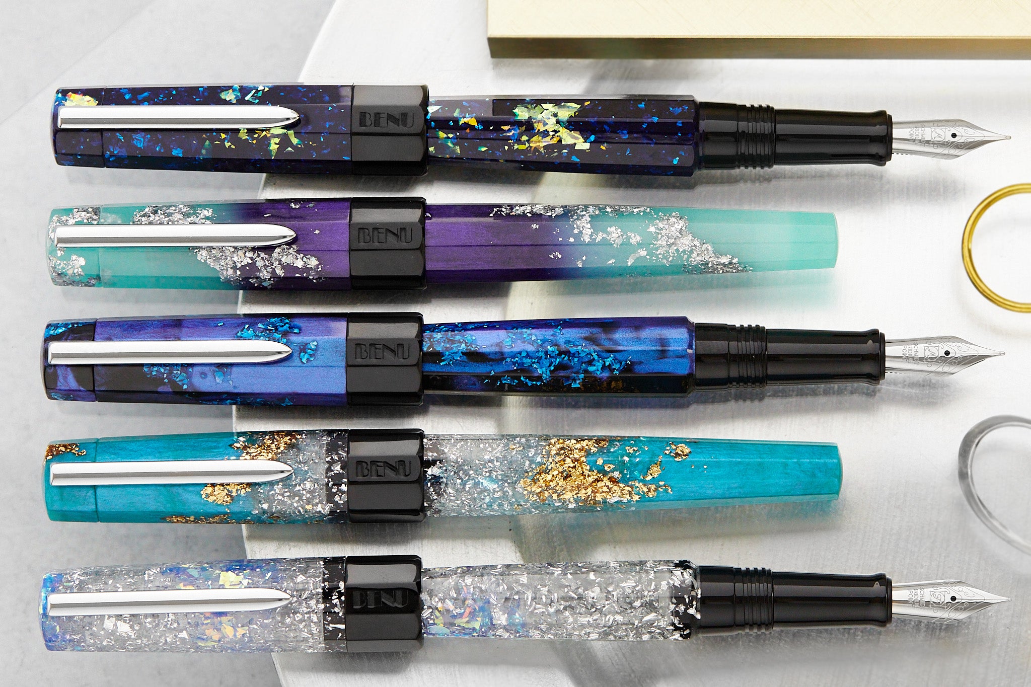 5 glittery BENU Euphoria fountain pens in a row