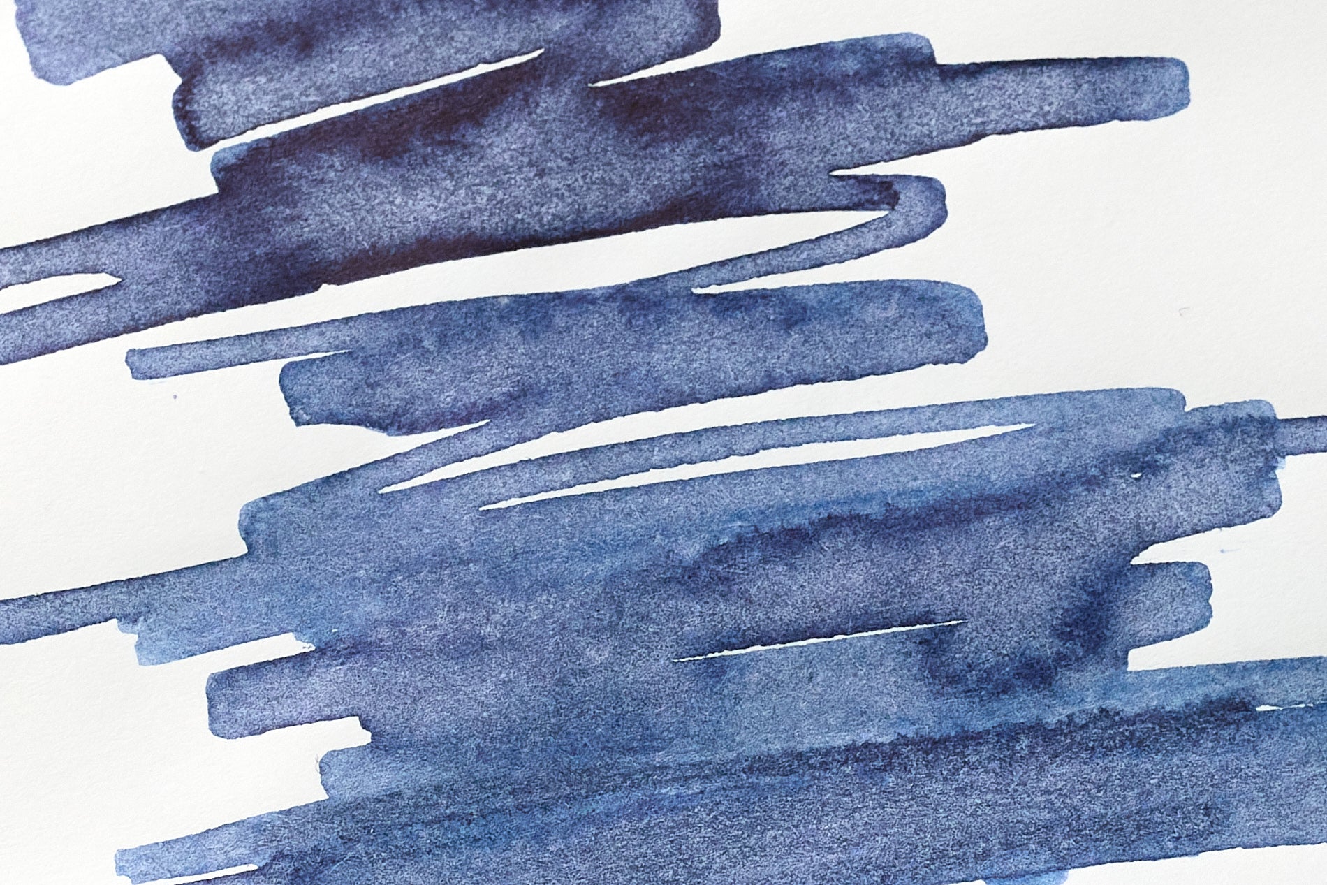 Close-up of De Atramentis Document Ink Fog Grey fountain pen ink "scratchy blob" doodle on white Tomoe River paper.