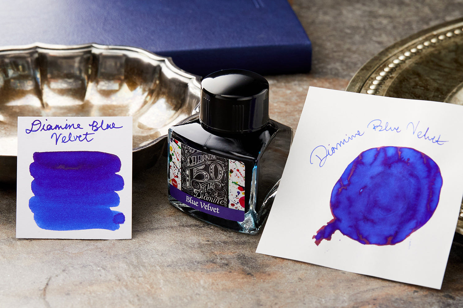 Diamine Blue Velvet Fountain Pen Ink bottle, and swabs on blue background