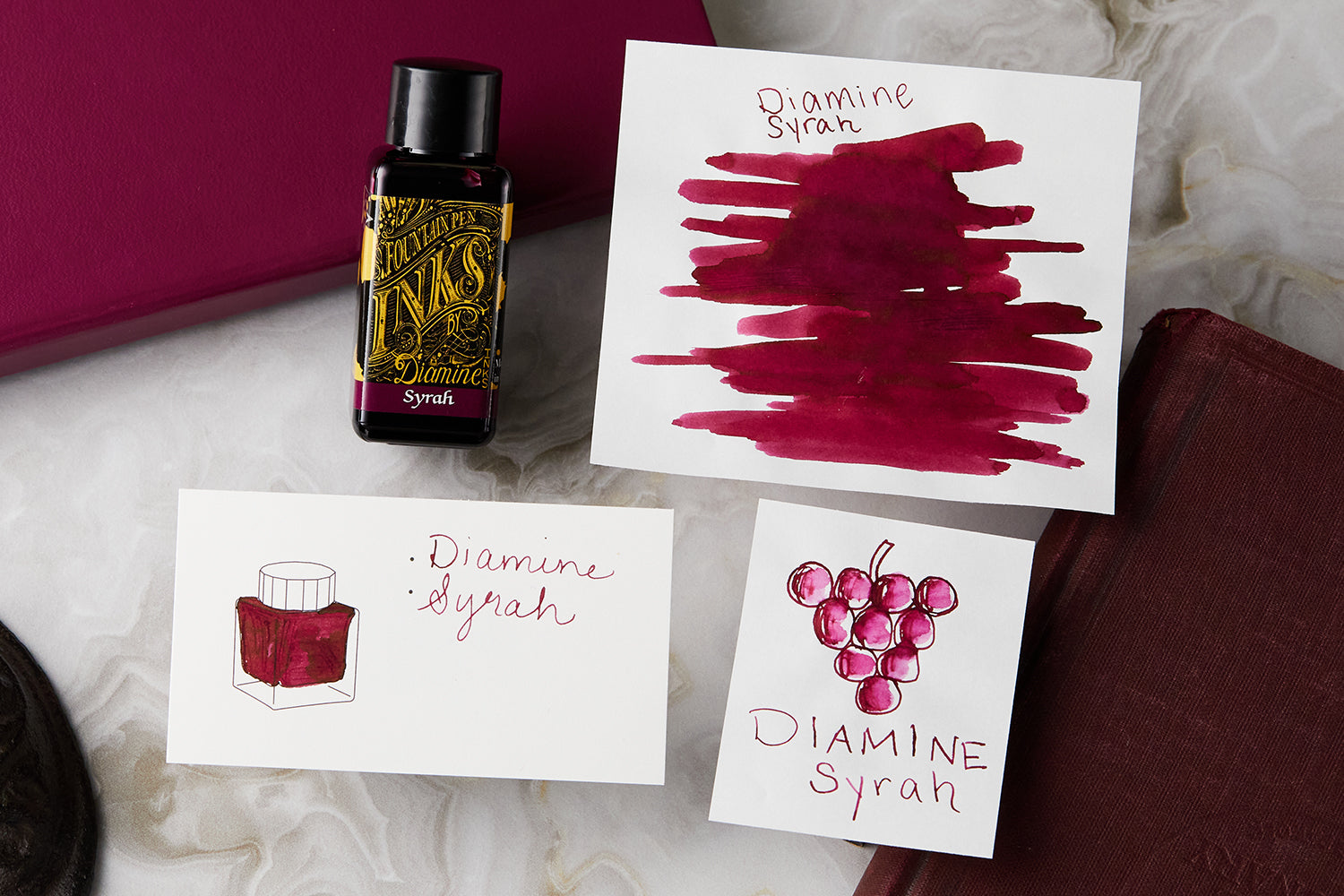 Diamine Syrah fountain pen ink drawing and ink color swatch card white marble background