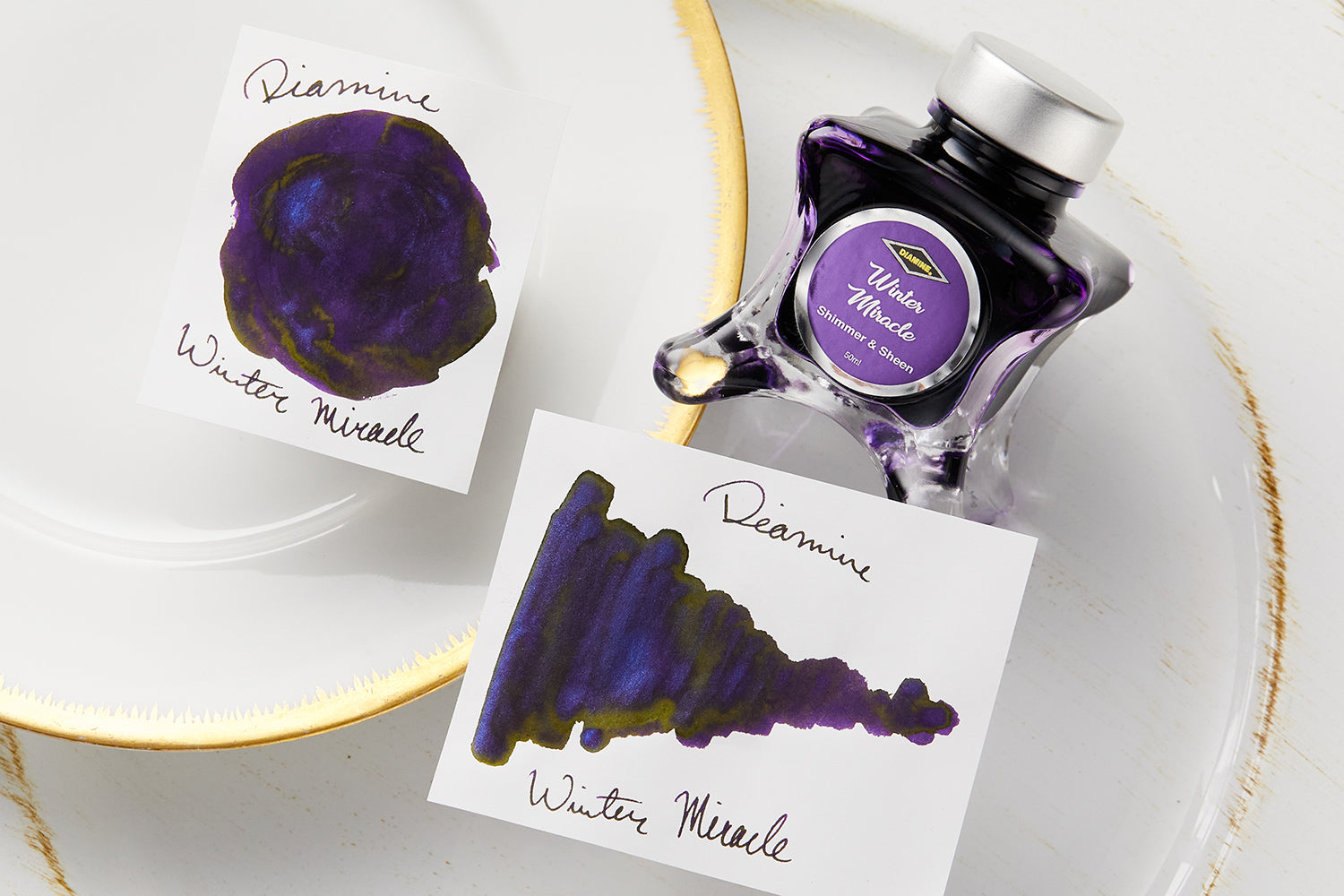 Diamine Winter Miracle Ink bottle with ink splatters
