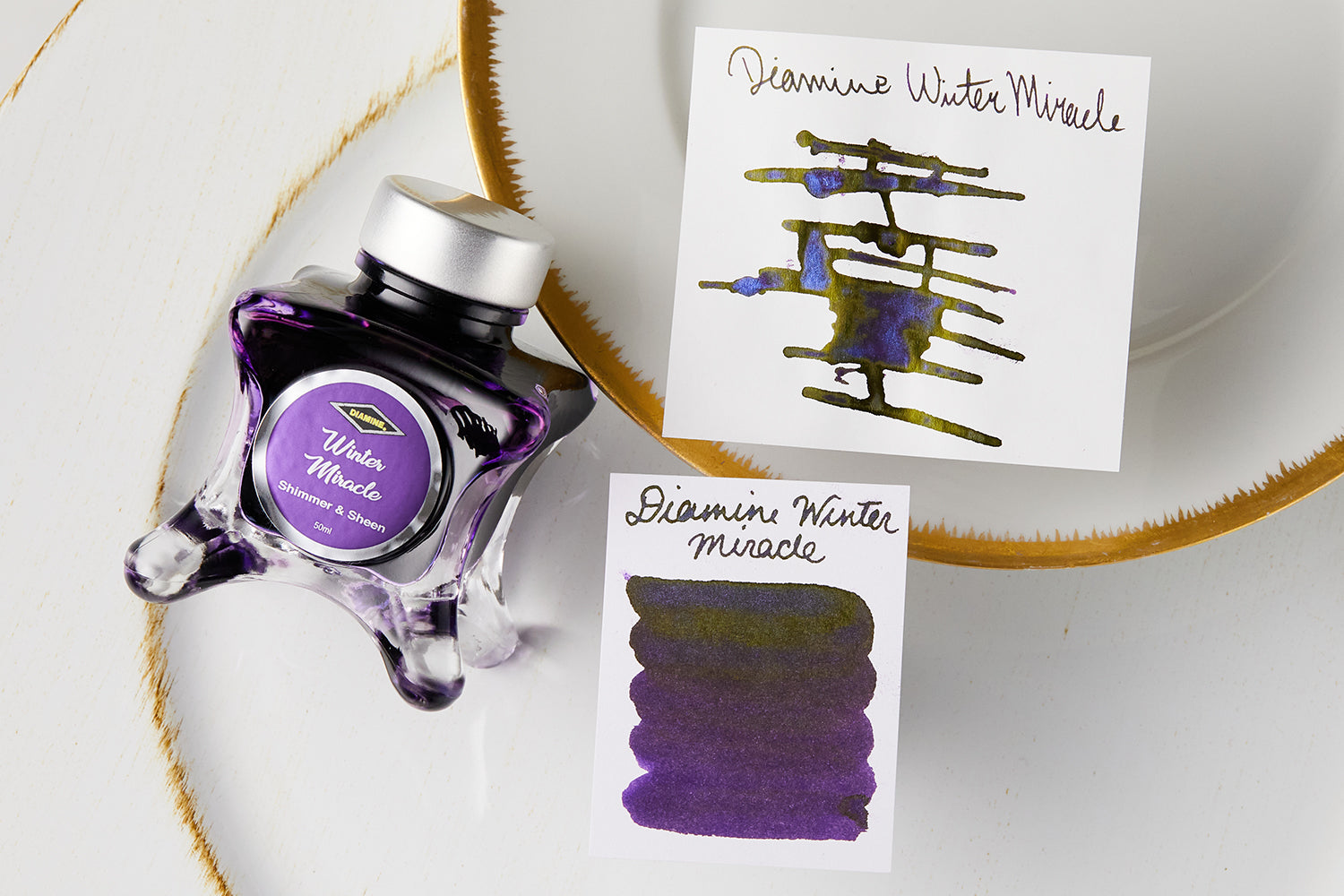 Diamine Winter Miracle Ink Bottle and swabs on white background