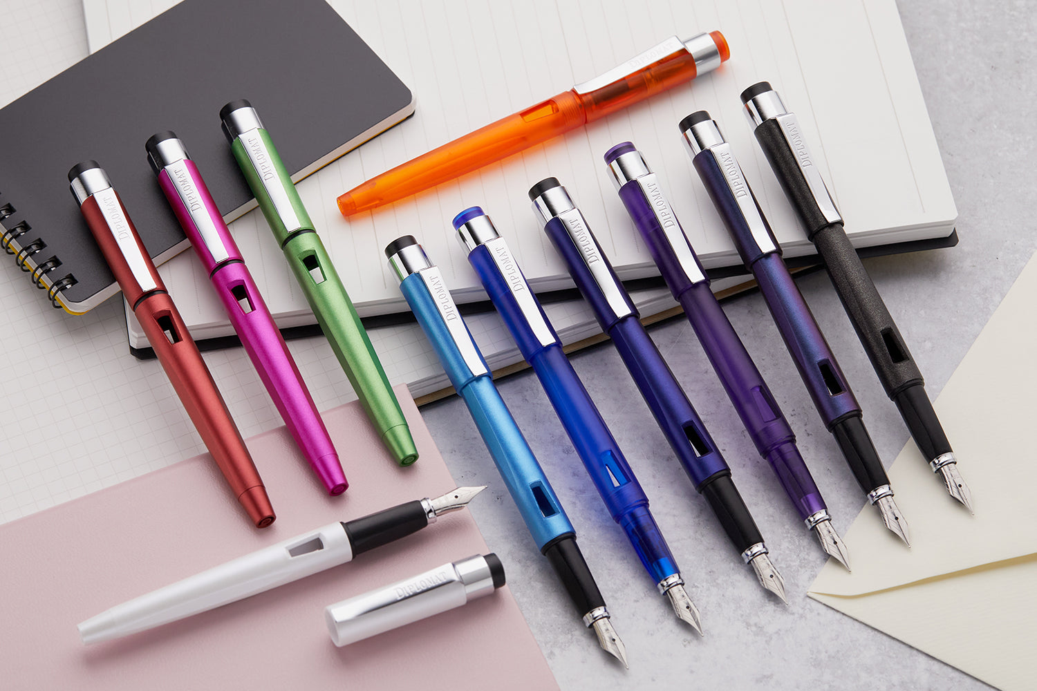 A large group of colorful fountain pens arranged in a row