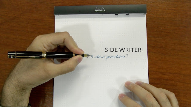 left hand in the side writer position over a notebook