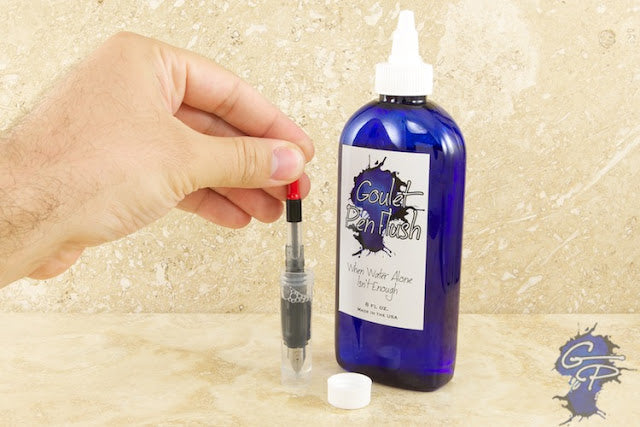 Goulet Pen Flush bottle with a nib unit and converter being cleaned