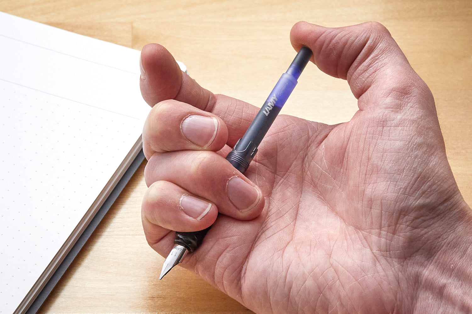 Pushing an ink cartridge into a LAMY fountain pen