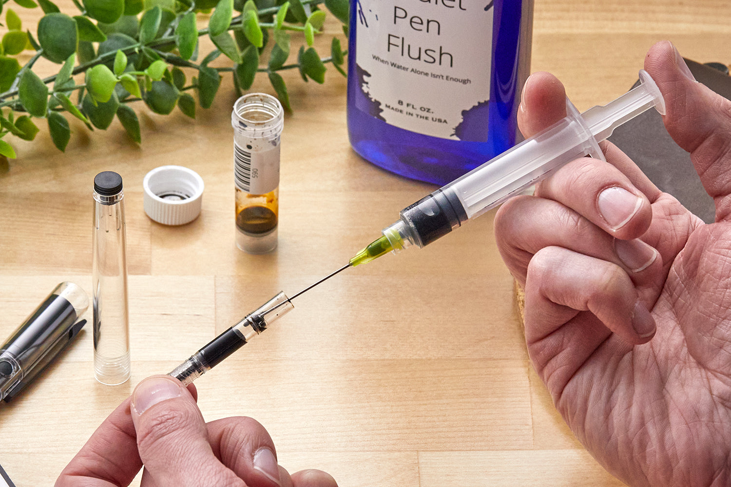 Filling a converter with an ink syringe