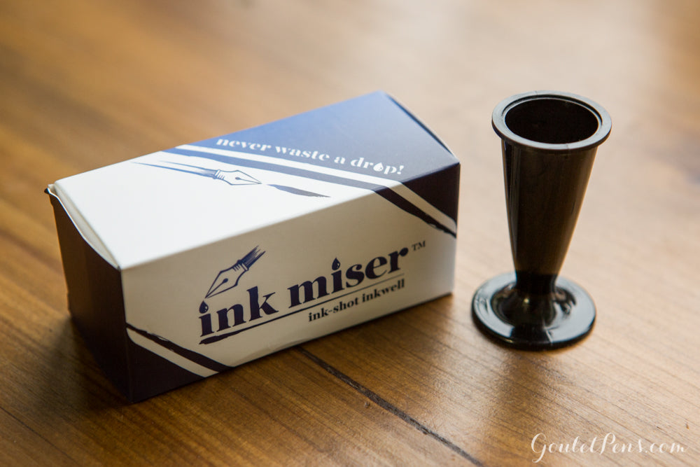 Ink Miser Ink-Shot Inkwell and box on wooden background