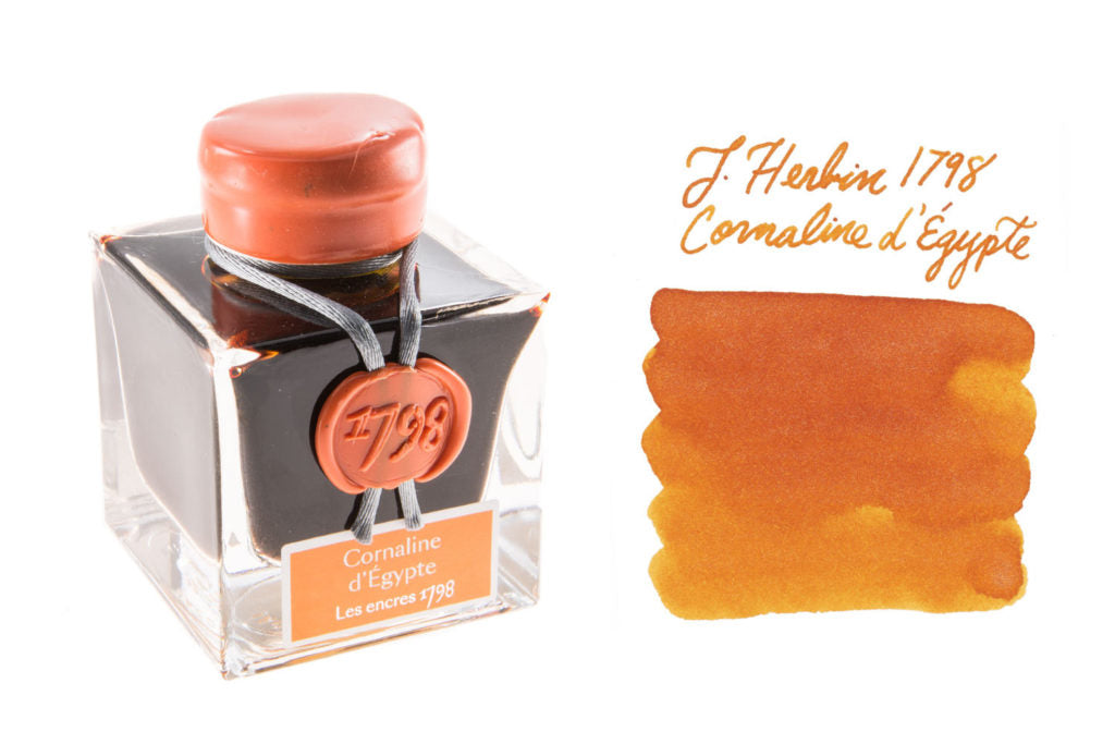 Bottle of Jacques Herbin 1798 Cornaline d'Egypte fountain pen ink with writing sample