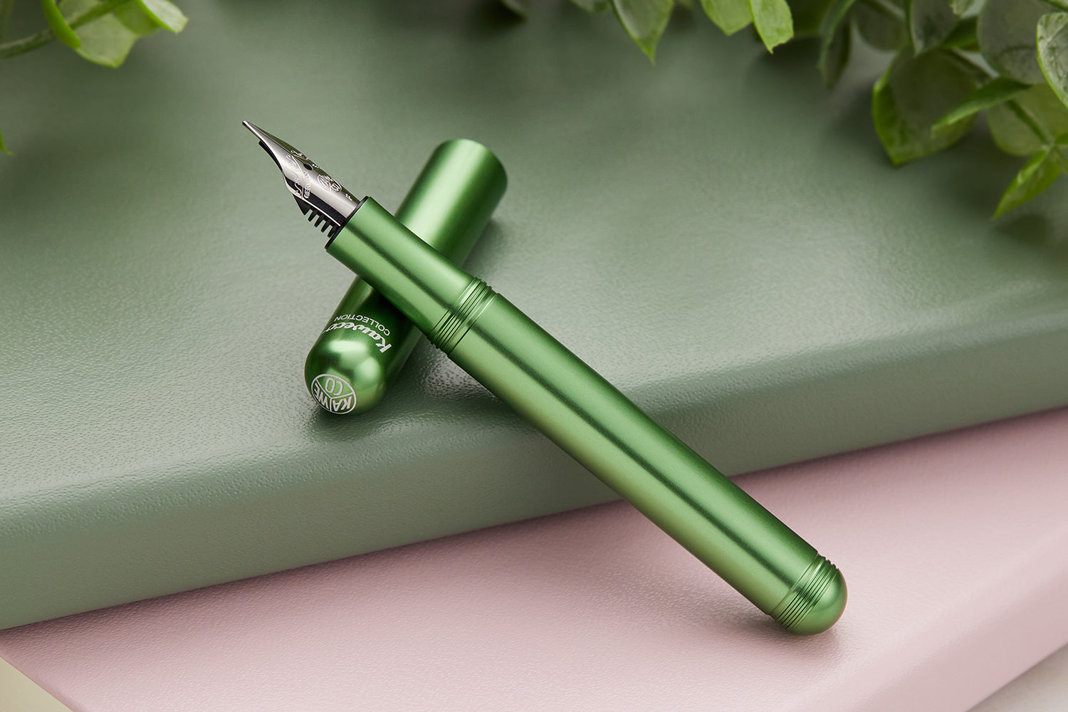 Green Aluminum Kaweco Liliput fountain pen on green notebook 