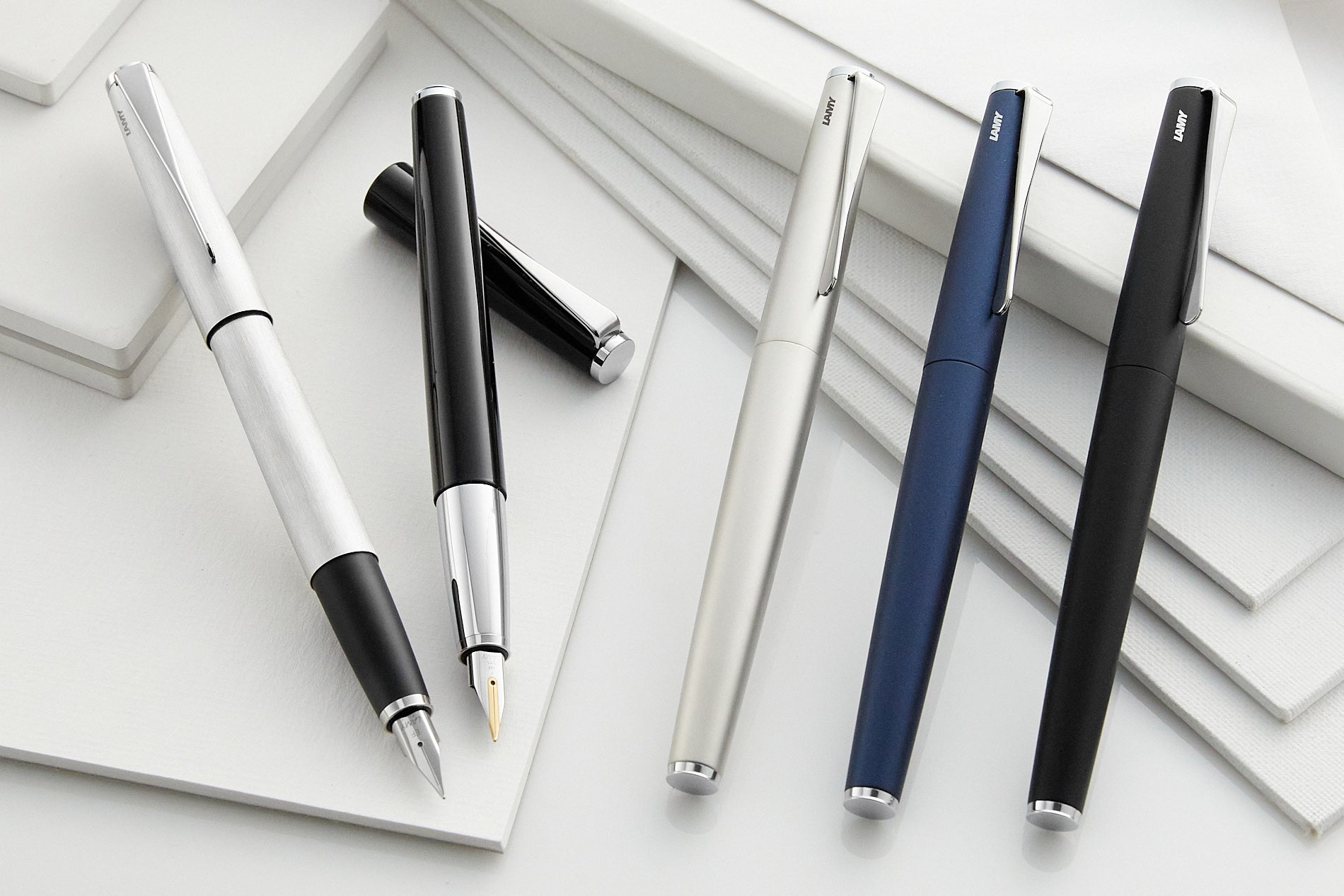 A group of LAMY studio fountain pens on a white background