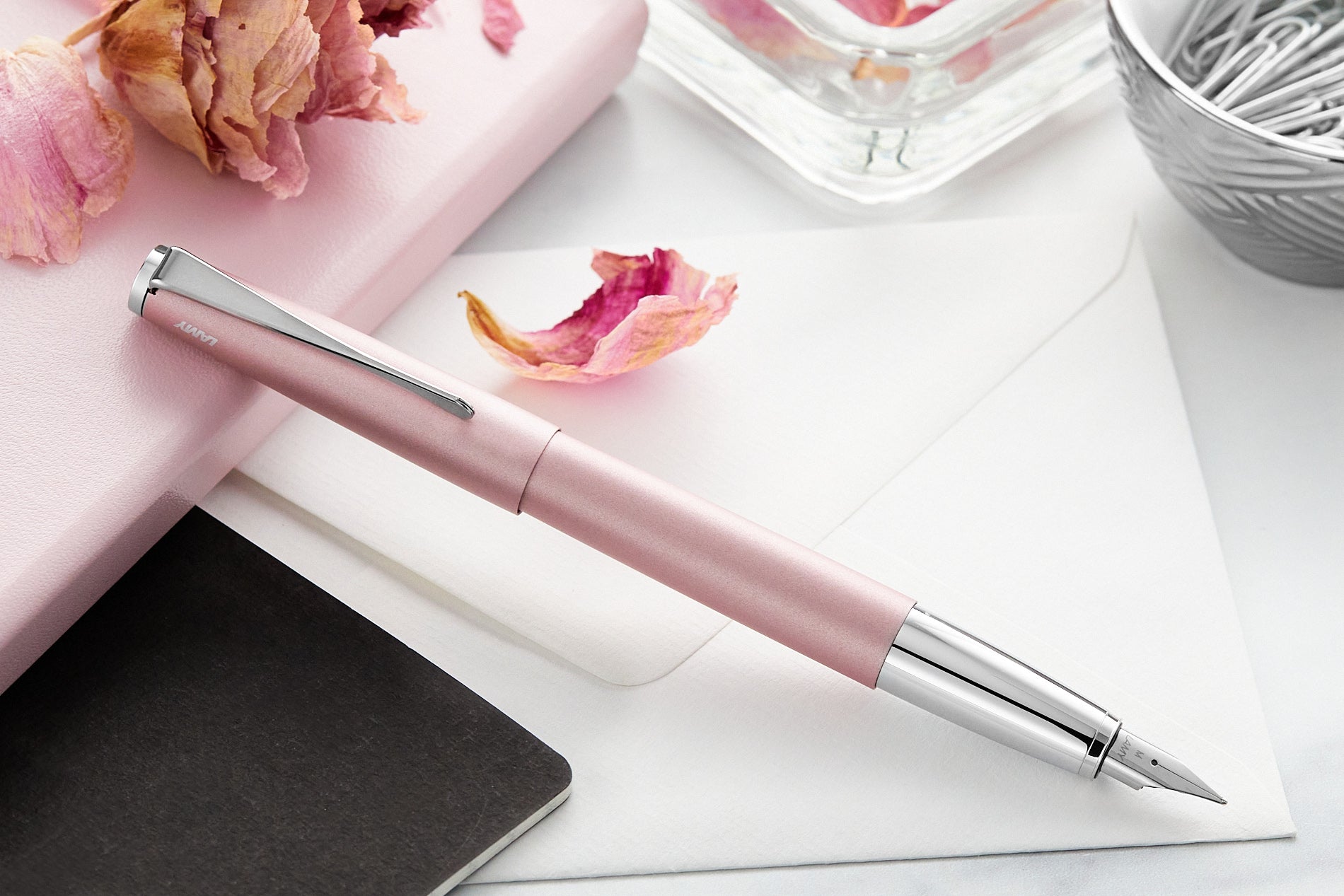 LAMY studio rose 2023 special edition fountain pen on desk with rose petals