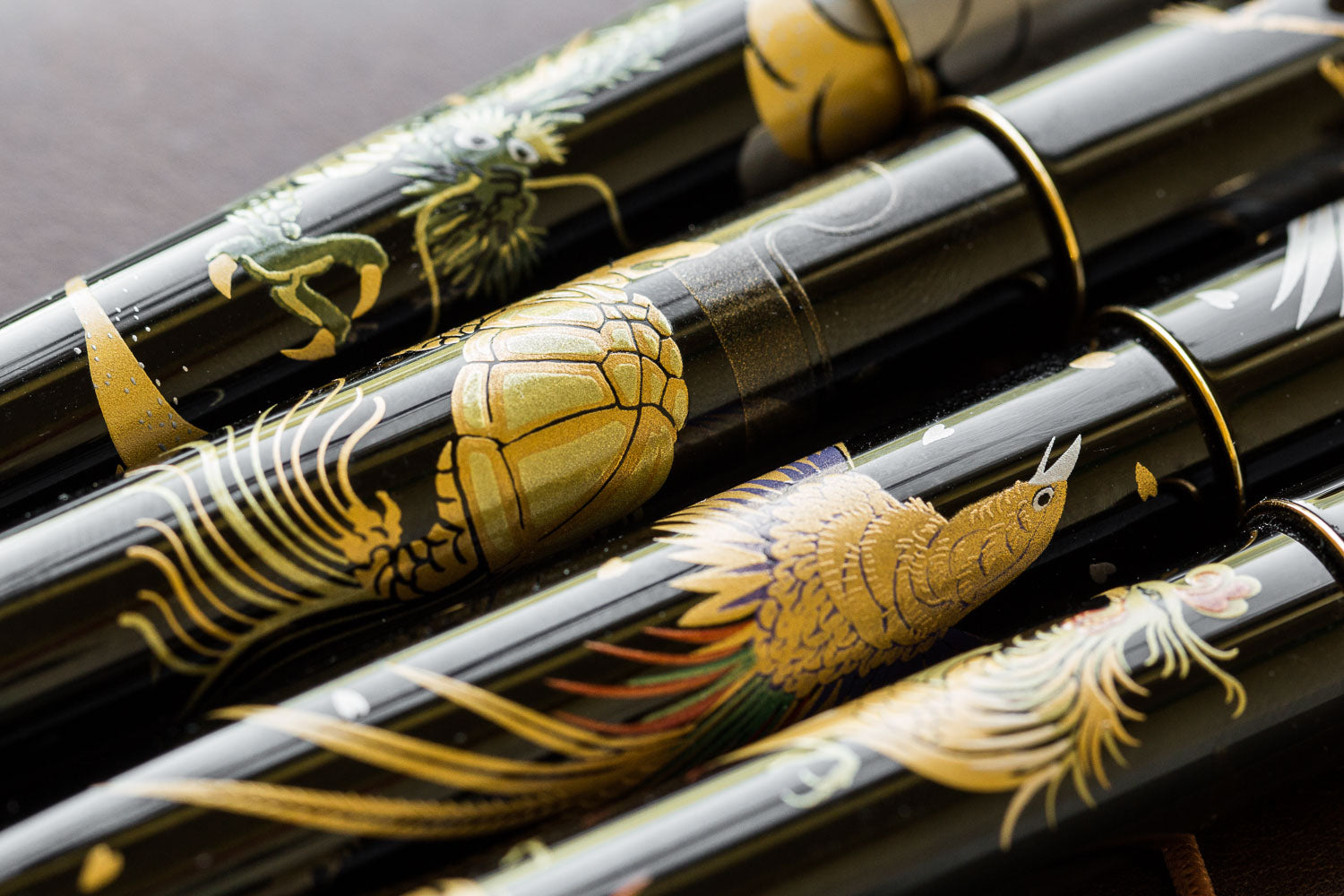 Close up of Namiki Nippon Art Maki-e fountain pens in four designs