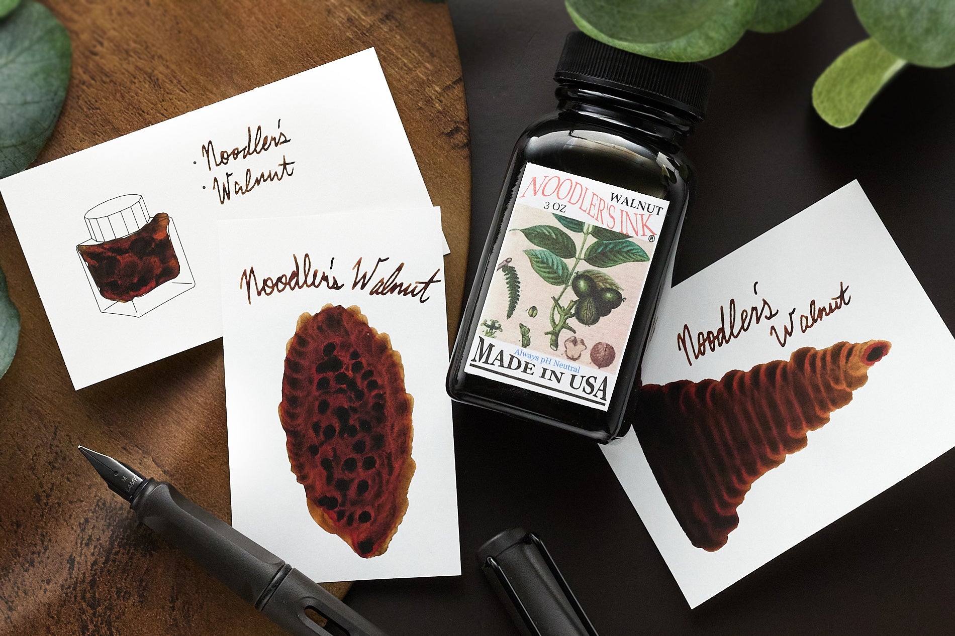 Noodler's Walnut Fountain Pen Ink bottle and ink samples on a Wearingeul swatch card and 2 white pieces paper