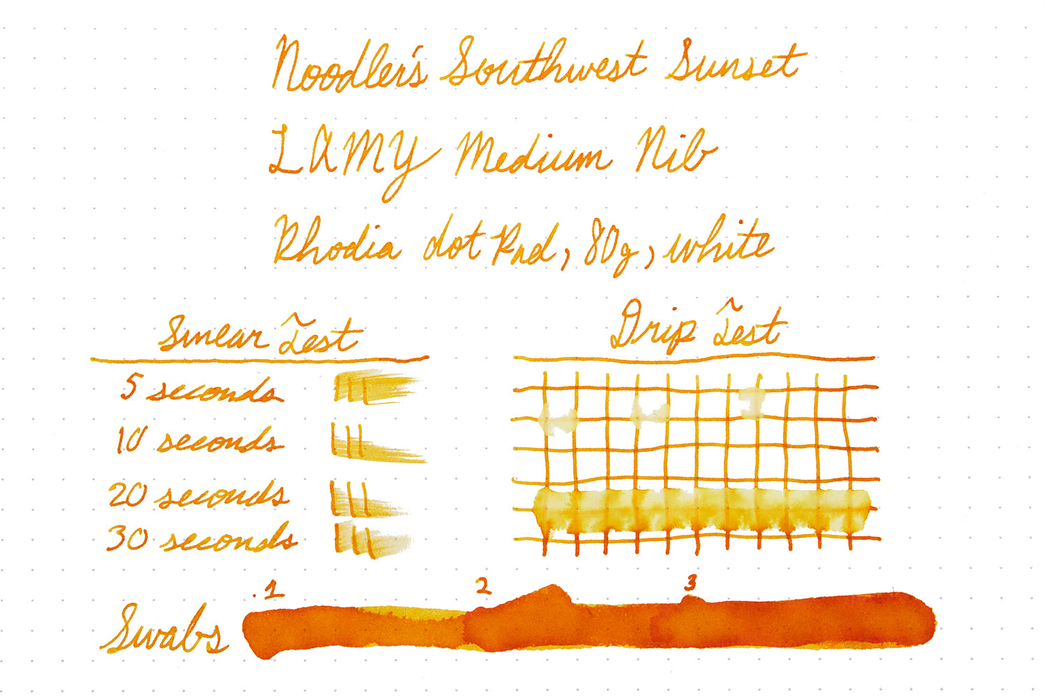 Bottle of Noodler's Southwest Sunset writing sample on white dot grid paper