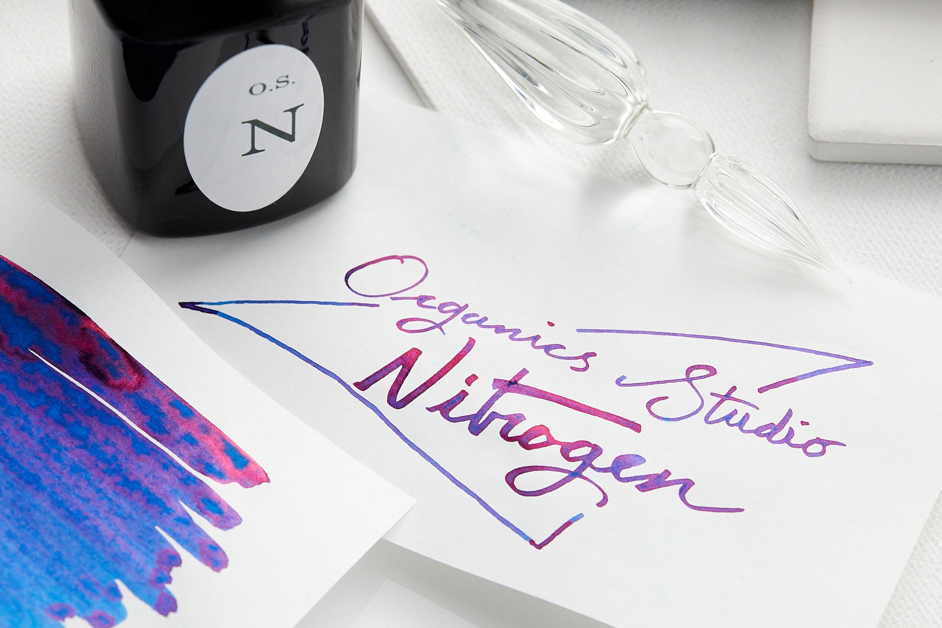 Organics Studio Nitrogen ink writing sample, bottle and swab card on white background