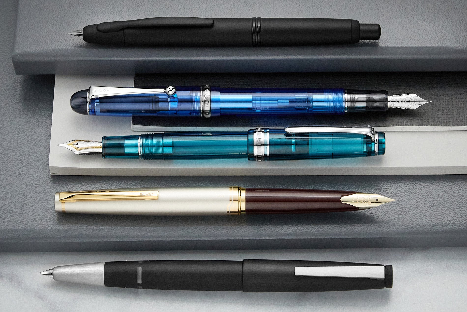 A group of five fountain pens