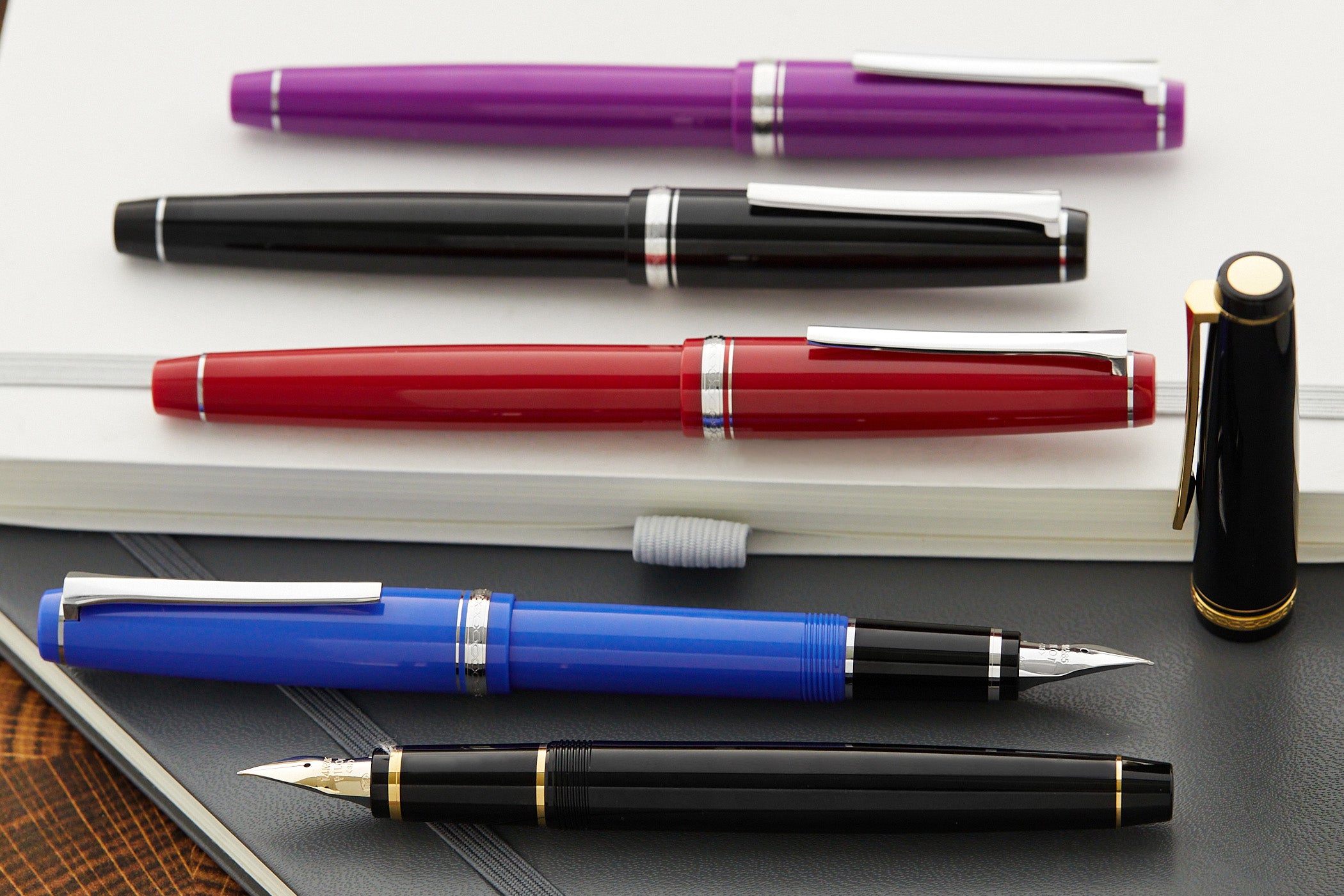 Colorful fountain pens in various positions