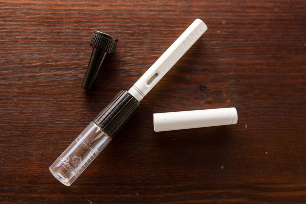 Pineider Pen Filler  and a fountain pen