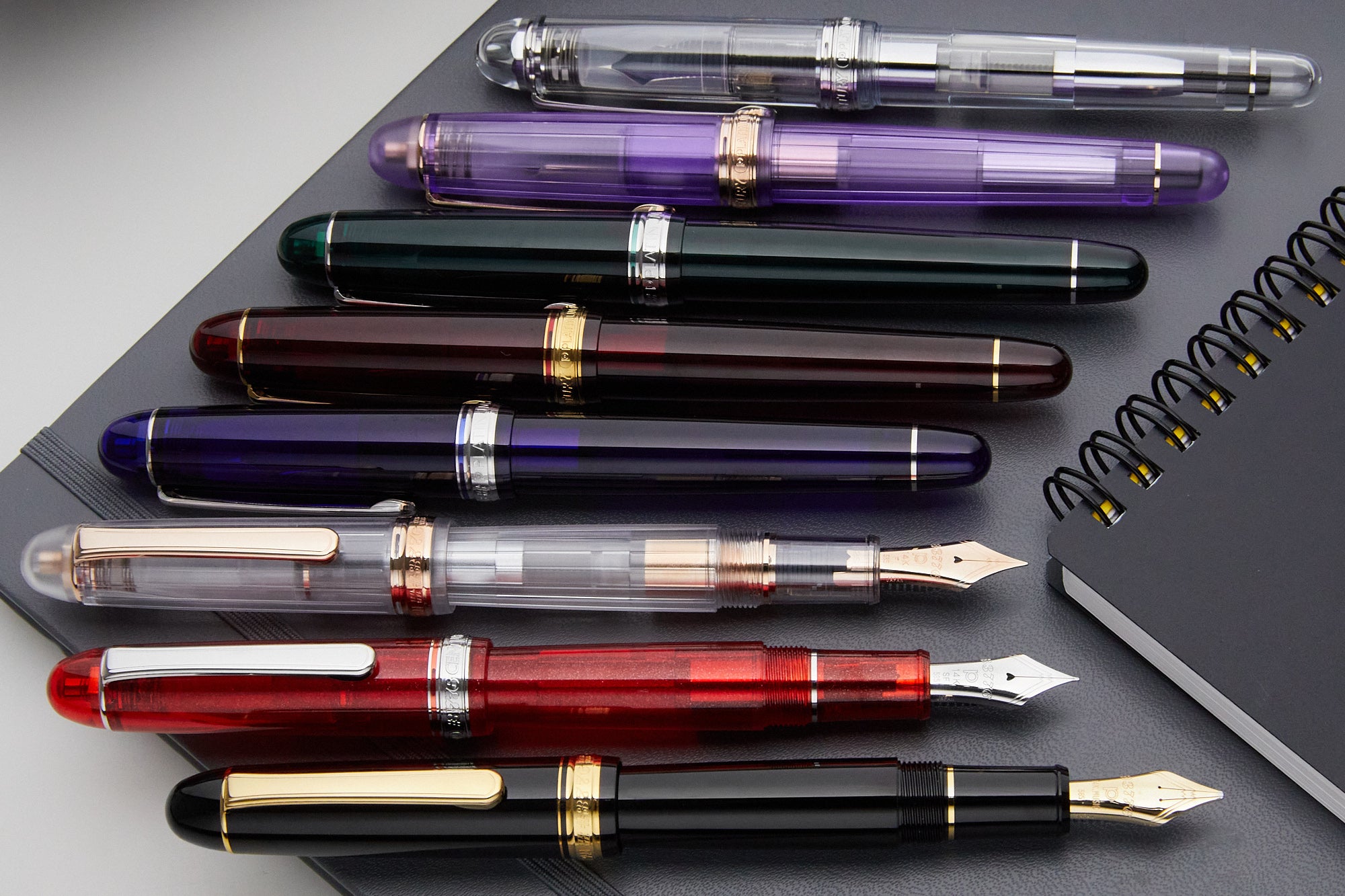 A neat angled lineup of colorful fountain pens