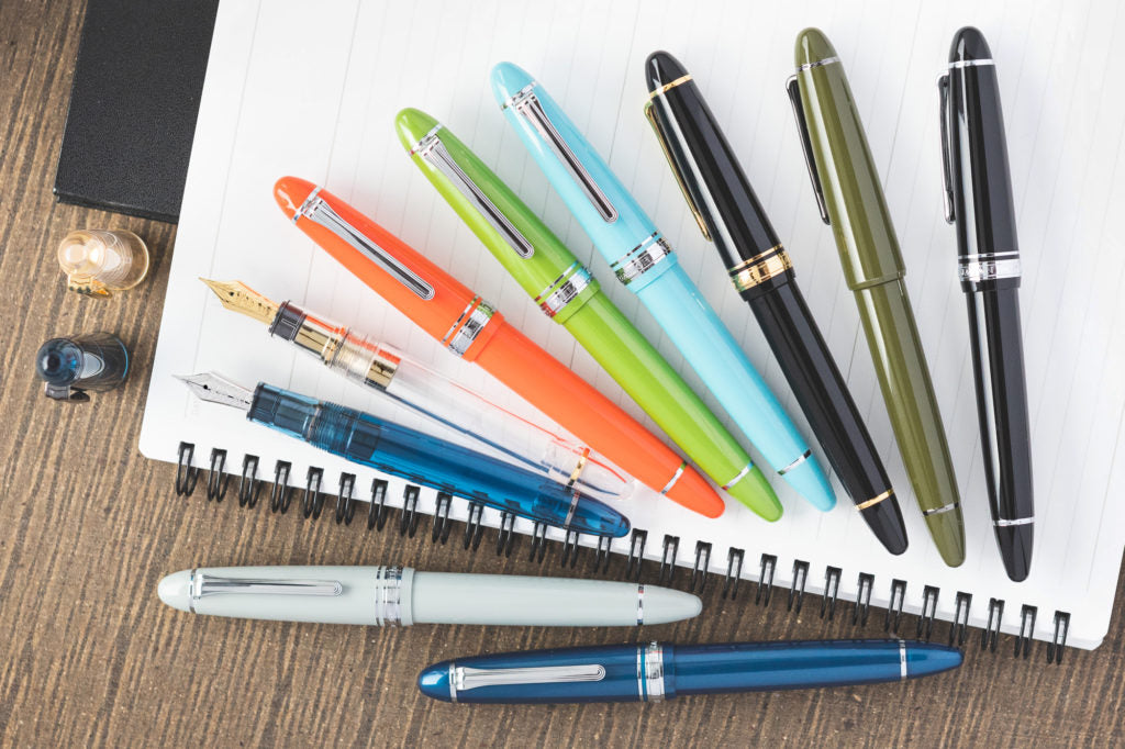 Sailor 1911L assorted colors, uncapped and capped on lined notebook