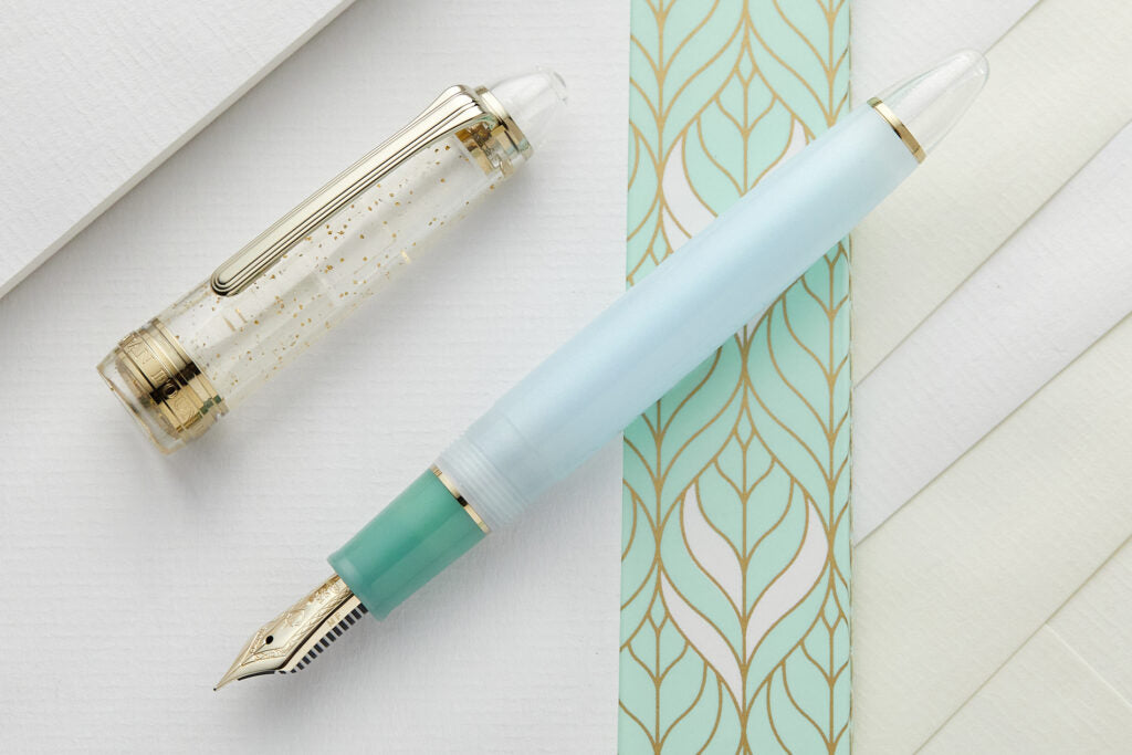 1911S pen with pale blue body, jade green trim and clear cap with sparlkes on mint green notebook