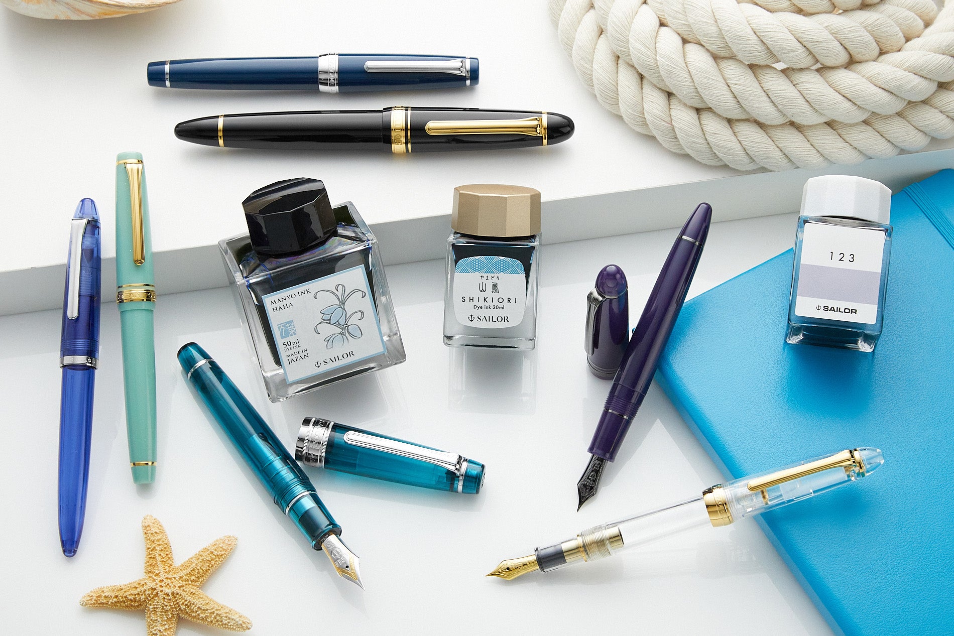 A variety of Sailor fountain pens and bottled inks
