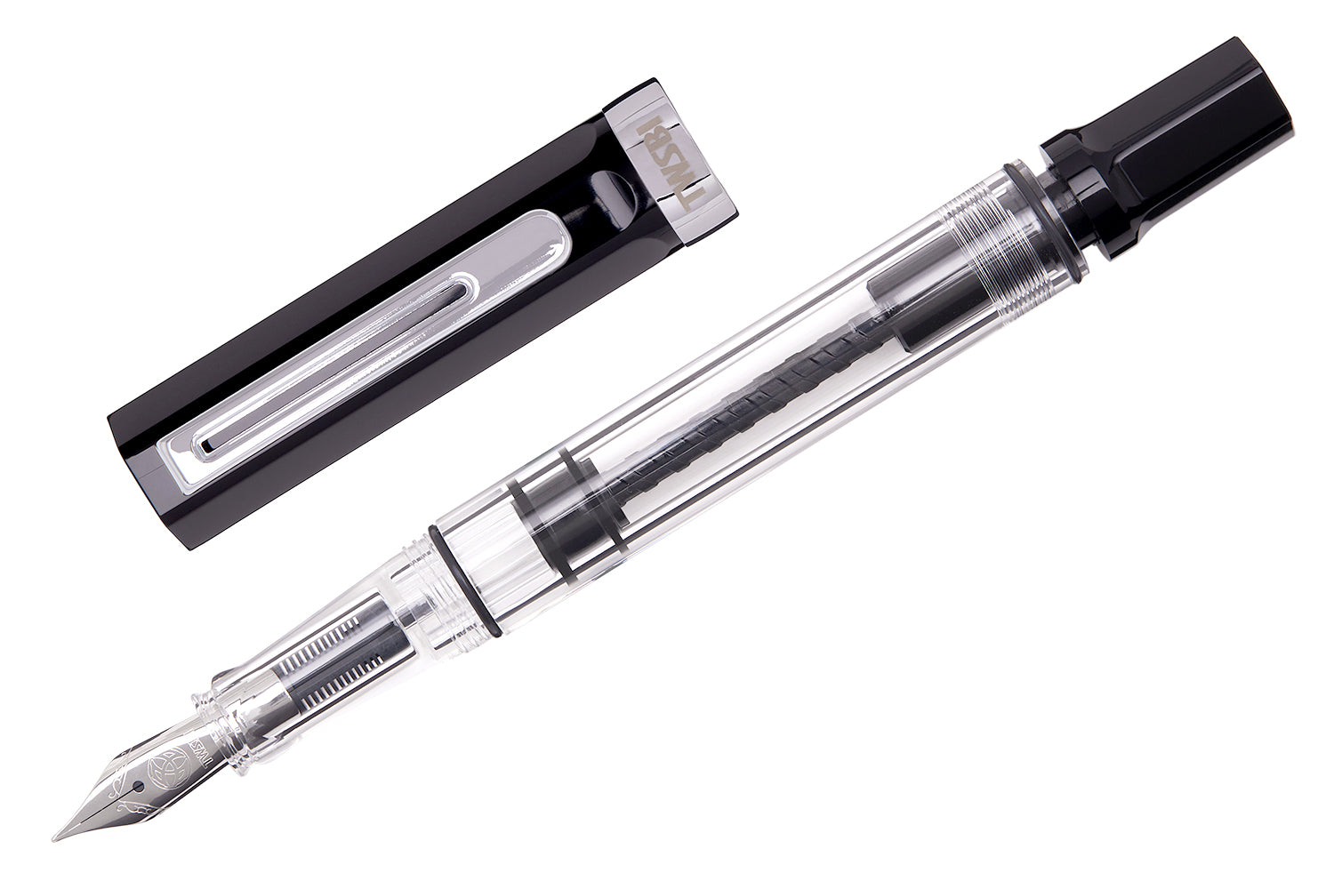 A clear fountain pen with a black cap, open, and showing the internal piston