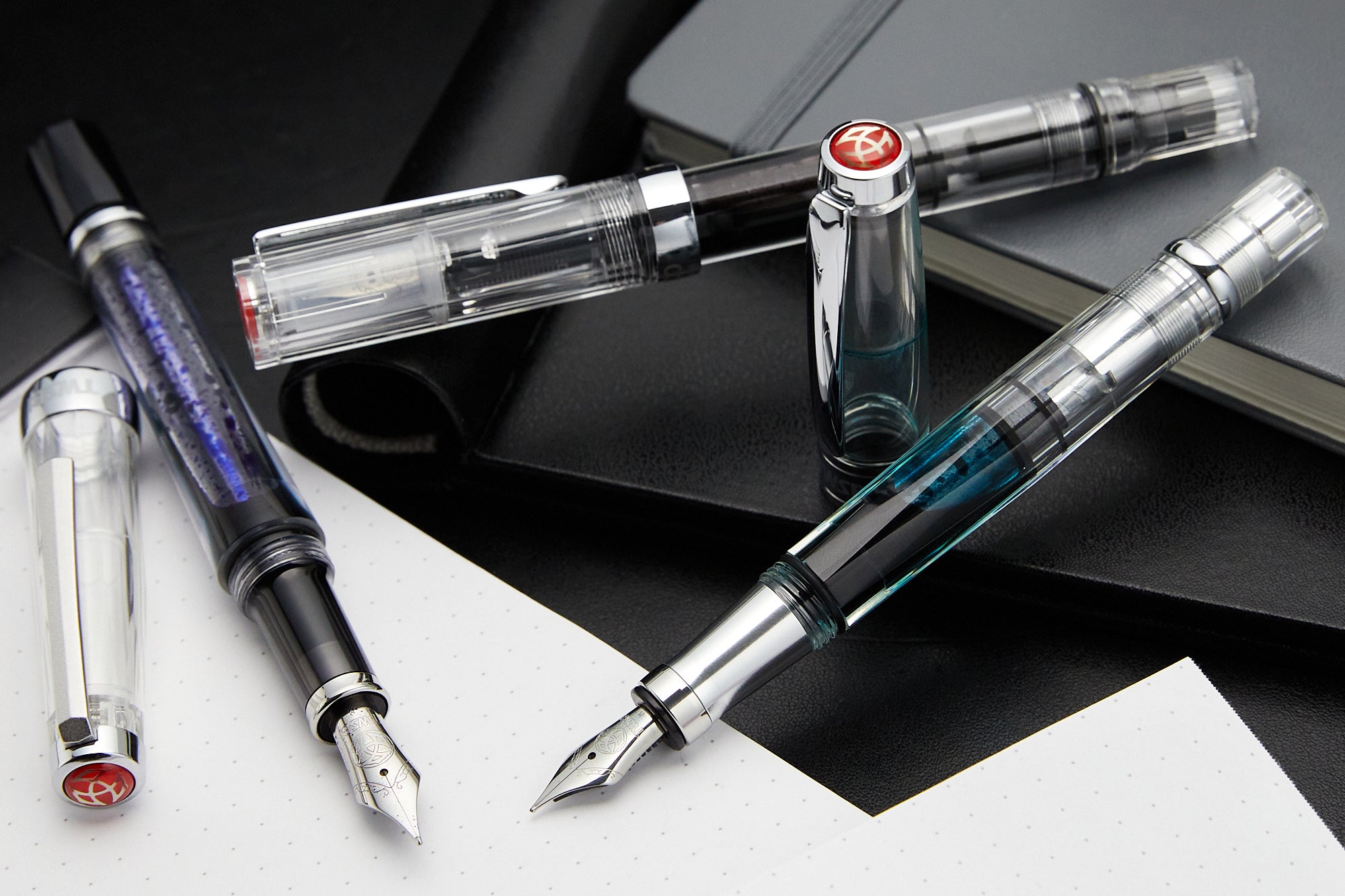 TWSBI fountain pens with various colors of ink inside