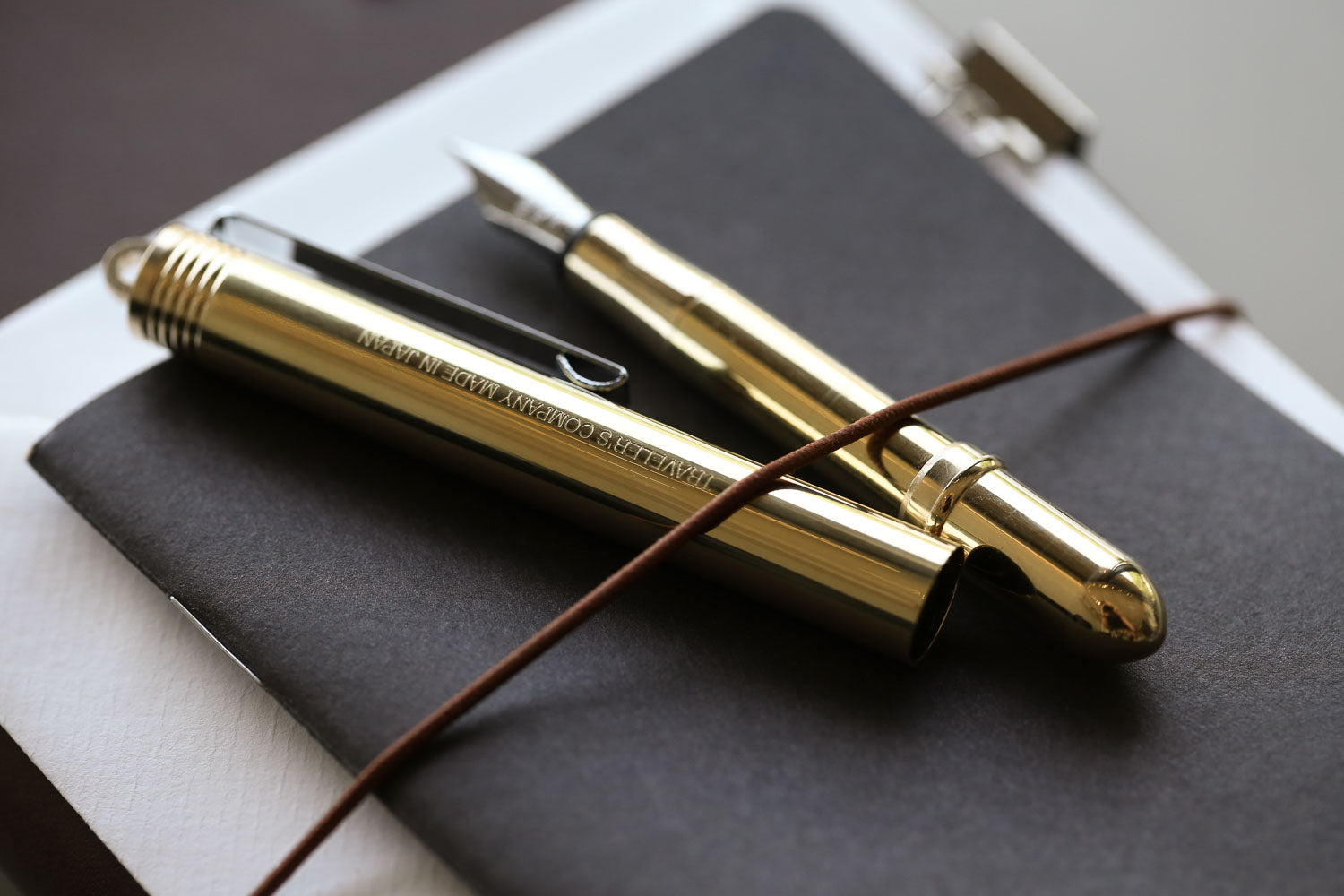 Travelers Brass fountain pen uncapped on Travelers Notebook