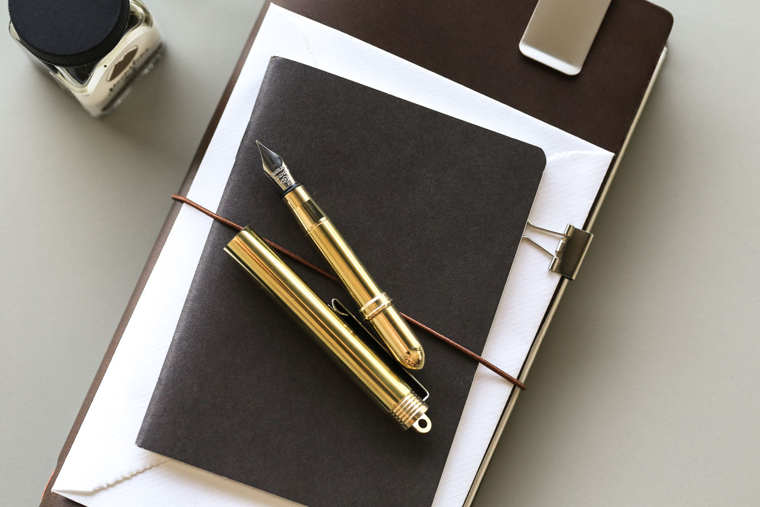Traveler's Brass fountain pen, on black notebook